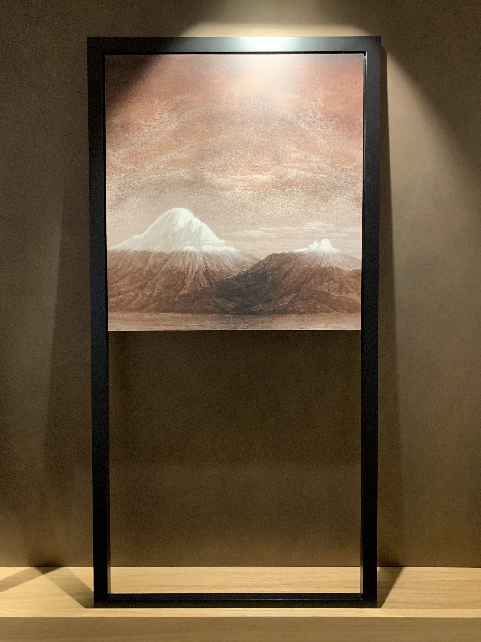 Two volcanoes in an open black frame